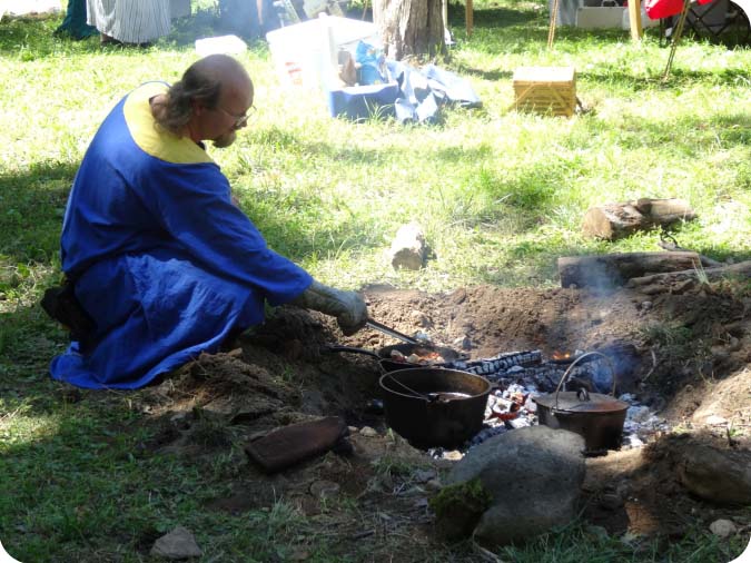 Lord Christoffel cooking at the firepit